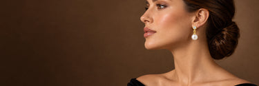 Model wearing yellow gold freshwater pearl drop earrings